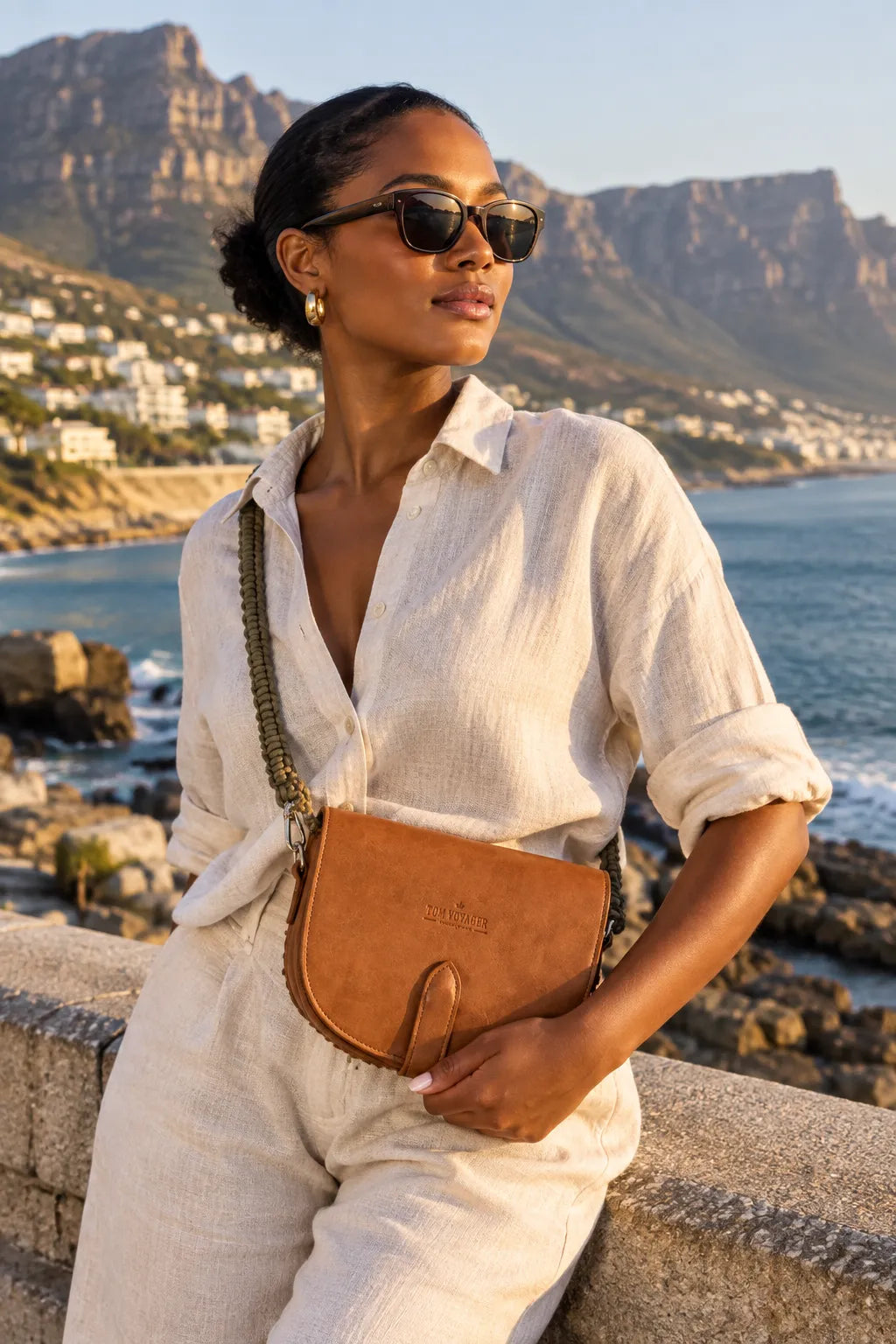 Woman holding Tom Voyager Clutch Bag